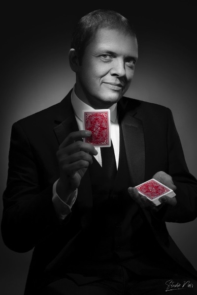 Portrait of Boris Wild holding red cards for Studio Noir
